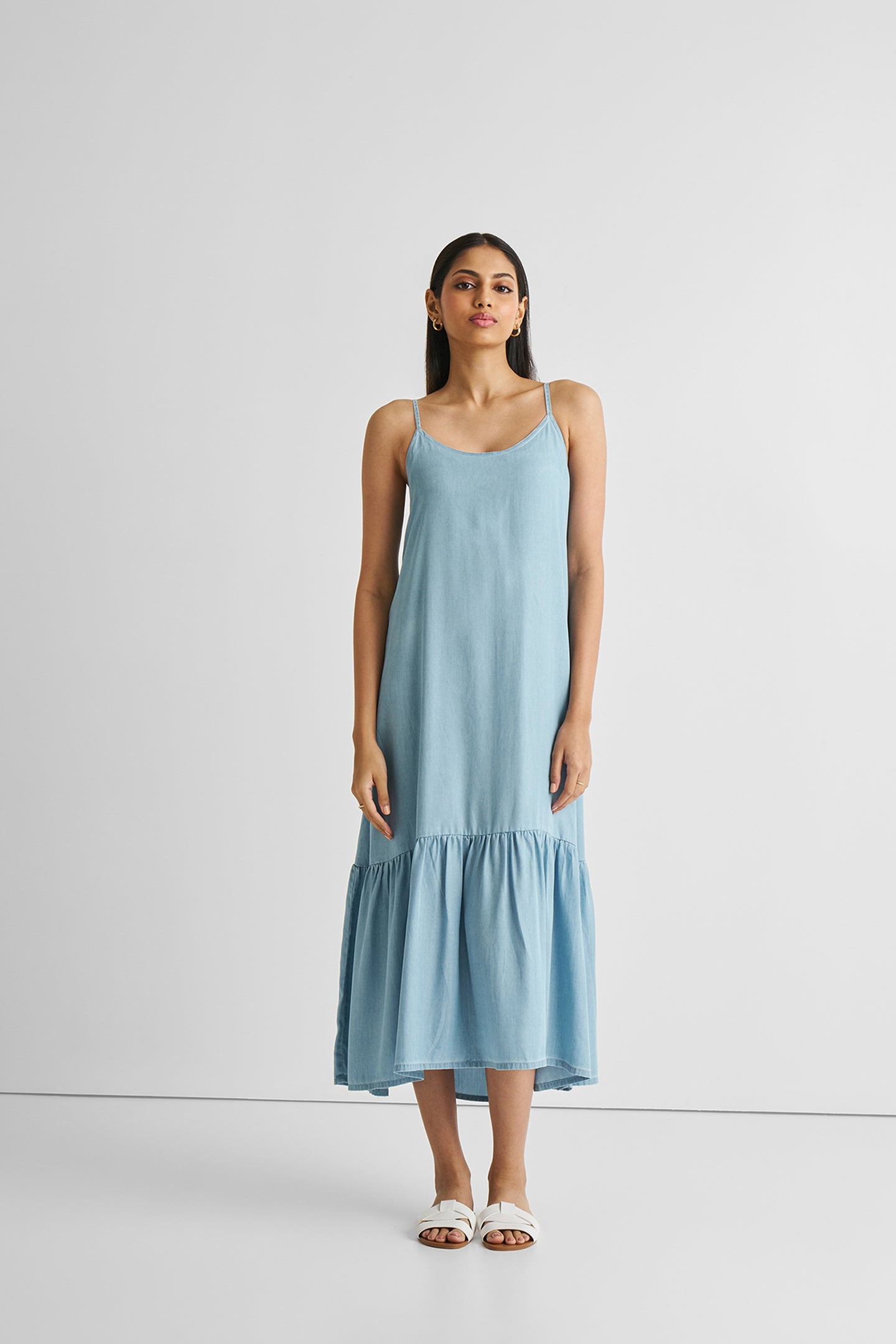Woman wearing a light blue dress on a white background