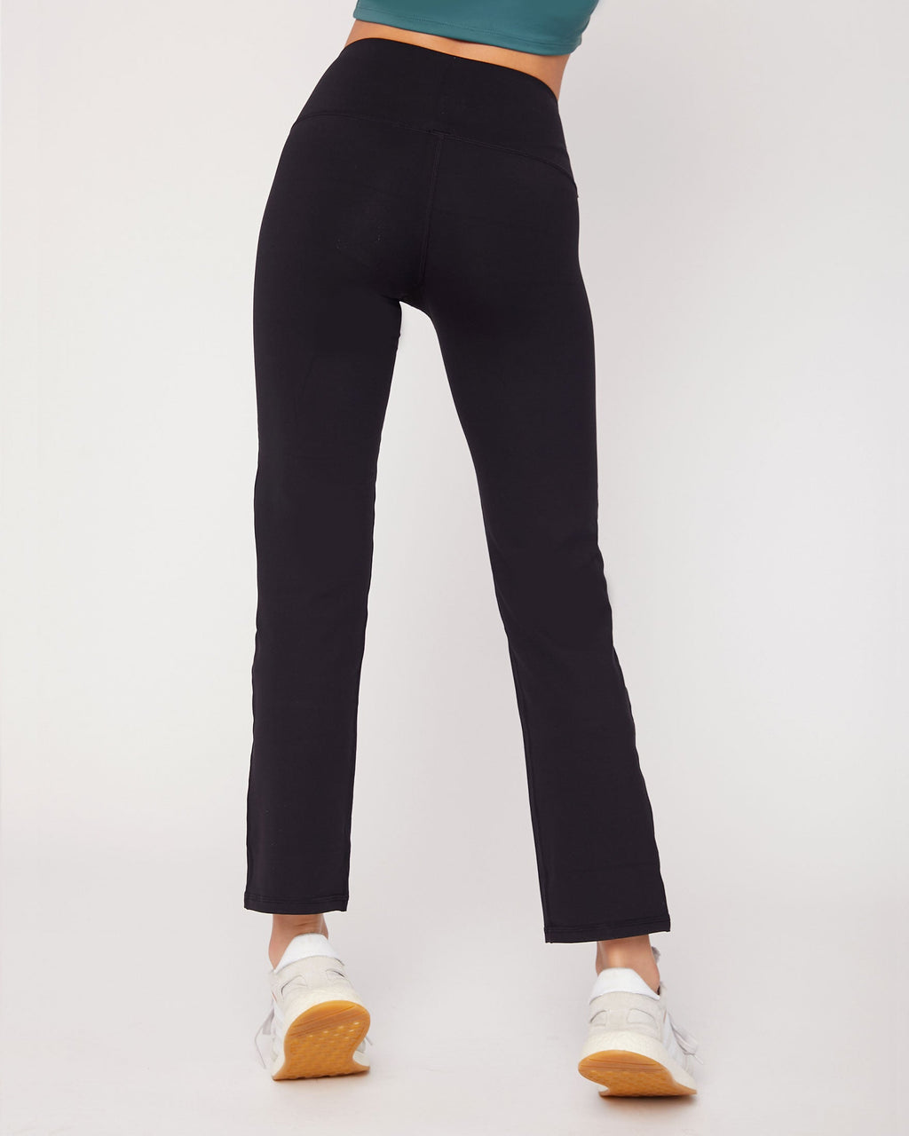 Person wearing black pants on a white background