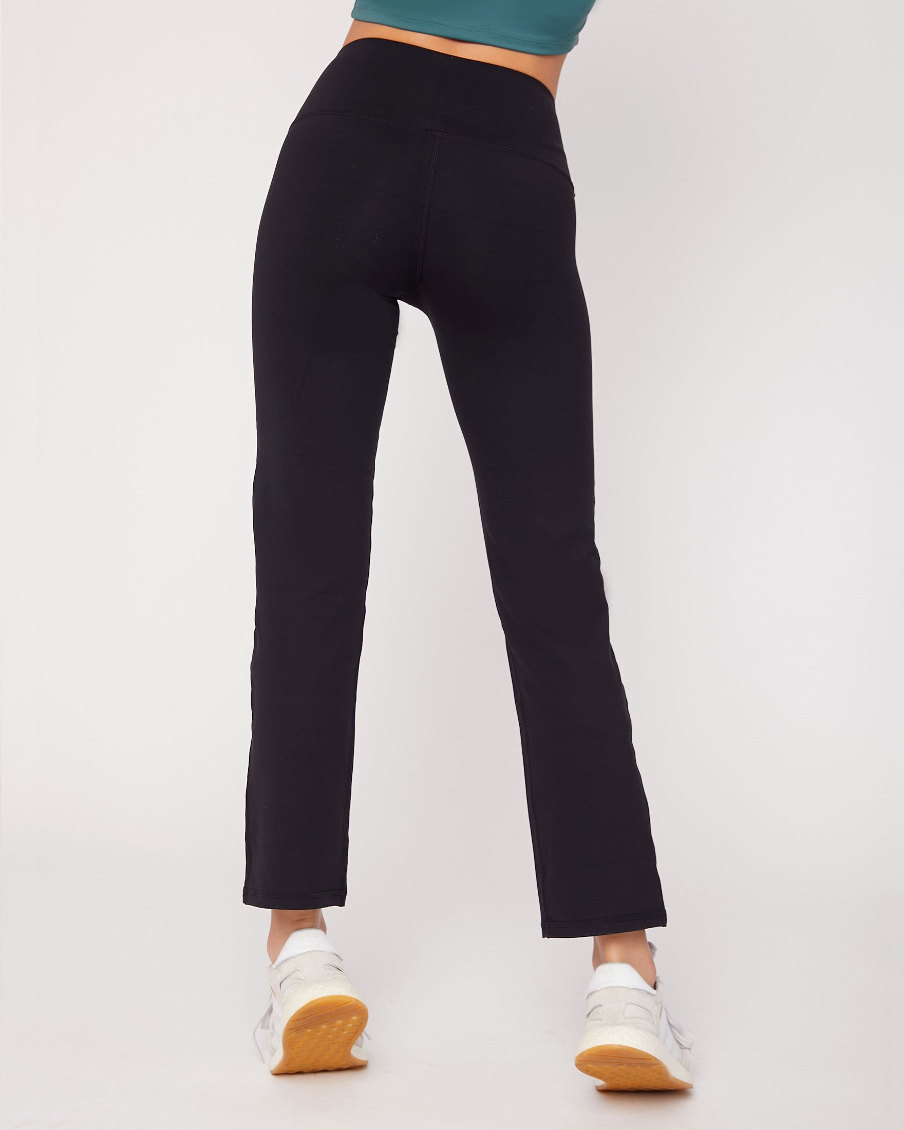 Person wearing black pants on a white background